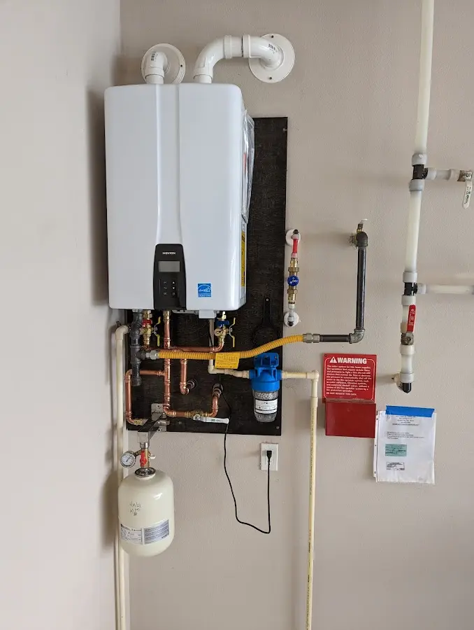 Professional plumber installing copper piping in a Kirksville home